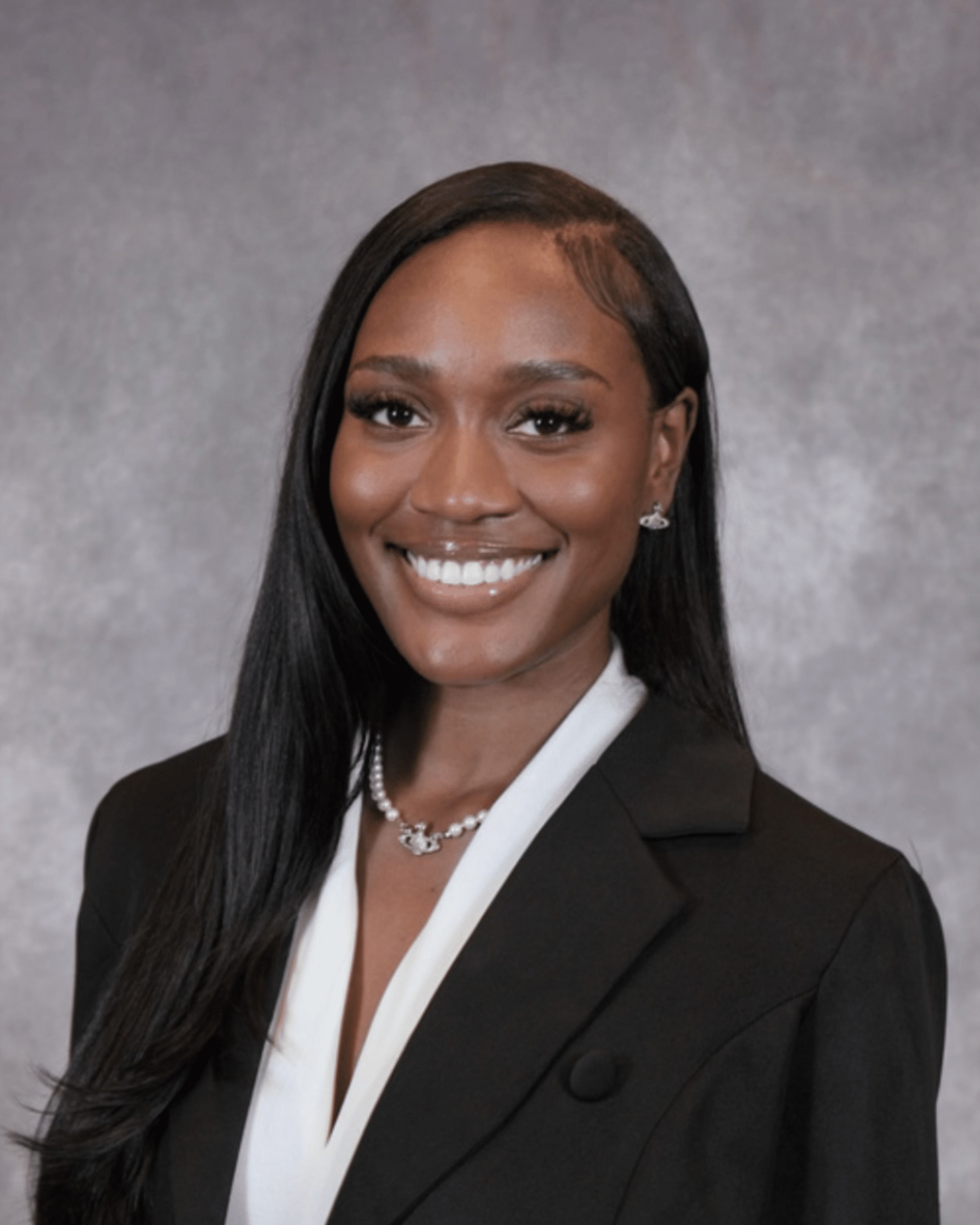 Dr. Karmen Ancar smiling, in a black blazer